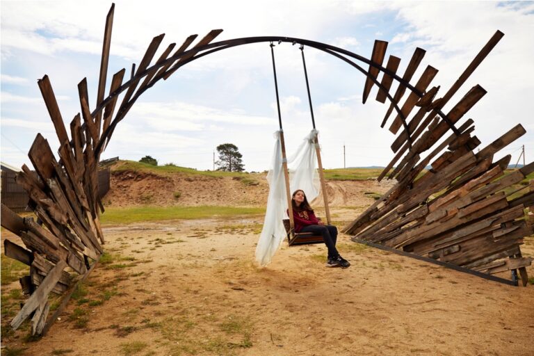 a teenage girl is sitting on a wooden swing art o 2022 10 31 07 22 53 utc