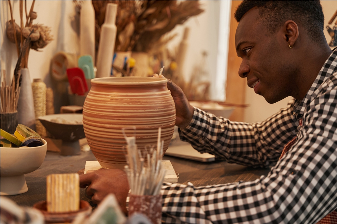 cheerful potter crafting new piece of pottery 2022 03 07 18 06 32 utc