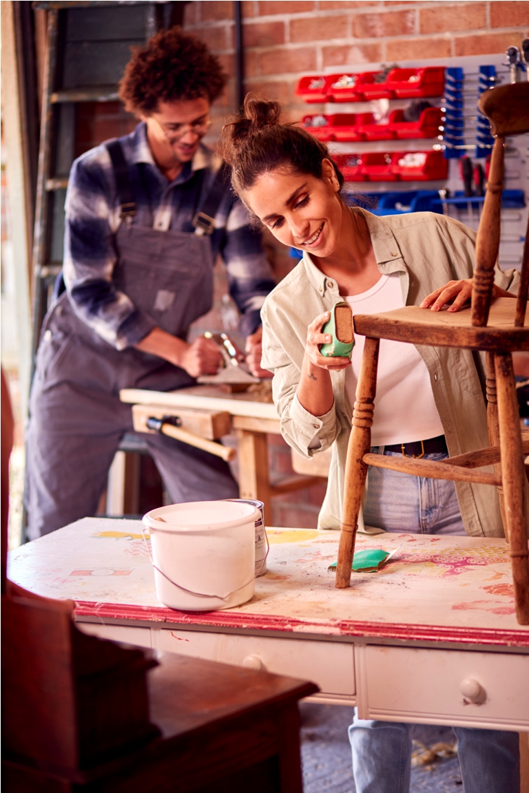 couple running business in workshop at home restoring and upcycling furniture