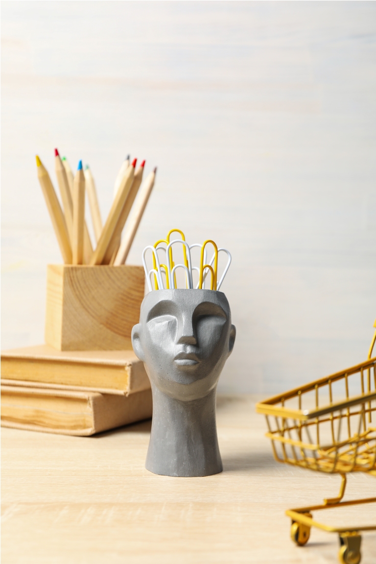 drawing concept with decorative head on wooden table
