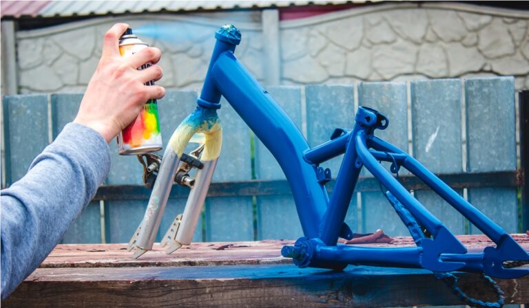 father paints a bicycle for a child. selective focus