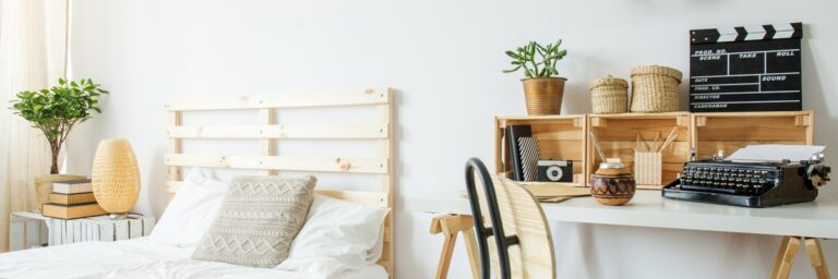 white bedroom with wooden bed, desk and chair, panorama