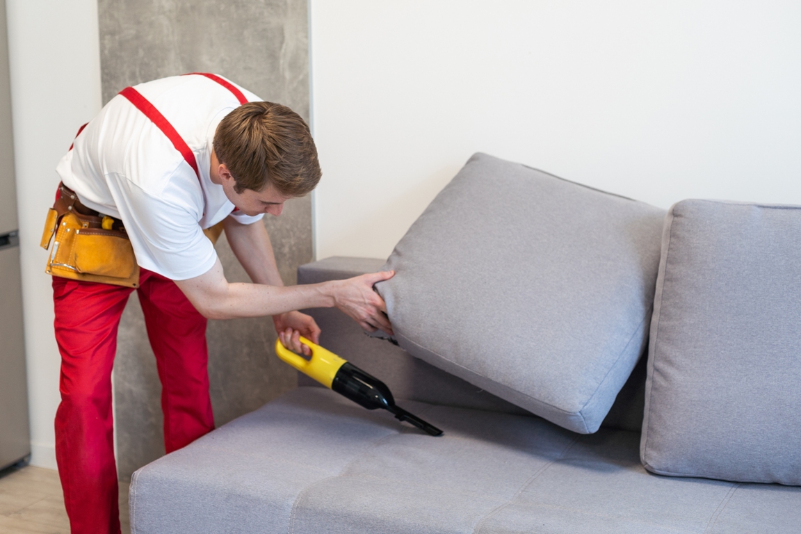 handsome young man cleaning furniture process of 2023 11 30 00 32 12 utc