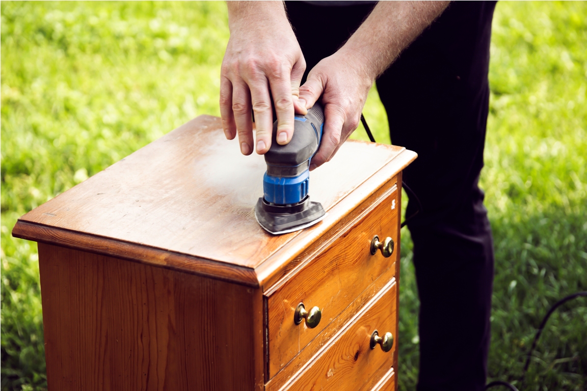 person using a grinder removes old paint from furn 2023 11 27 05 21 55 utc