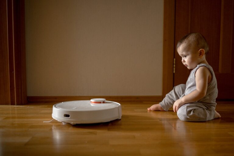 the baby is watching the robot vacuum cleaner 2023 11 27 05 27 12 utc