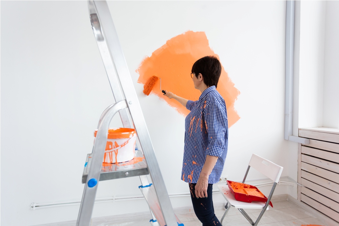 pretty smiling middle aged woman painting interior 2023 11 27 05 04 02 utc